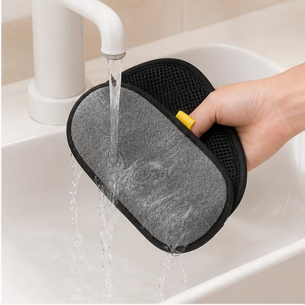 Washable pet hair remover glove rinsed under a faucet